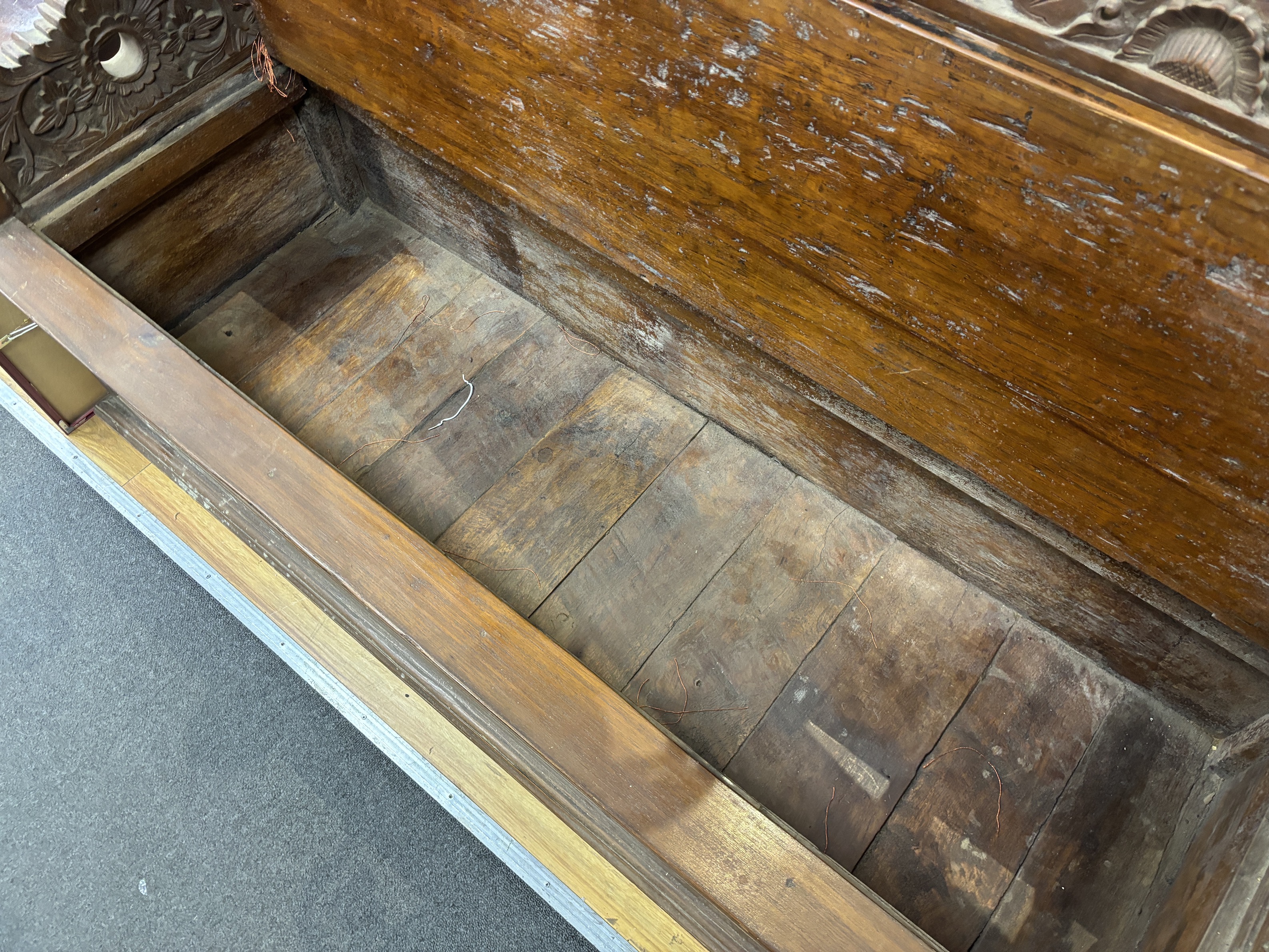 An Indonesian carved hardwood box seat settle, width 56cm, depth 56cm, height 98cm
